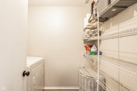 Laundry room at 12957 E 131st Street, Fishers, IN — Organized laundry room with ample wire shelving storage.