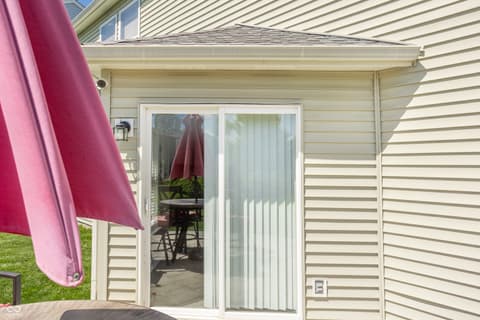 Outdoor living area at 12957 E 131st Street, Fishers, IN — Bright patio with sliding doors and shade options.