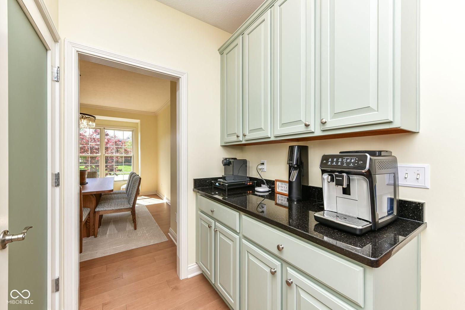 Bright kitchen with coffee bar and granite counters.