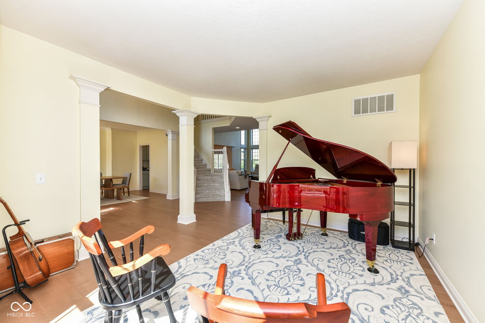Spacious music room with grand piano and open layout.