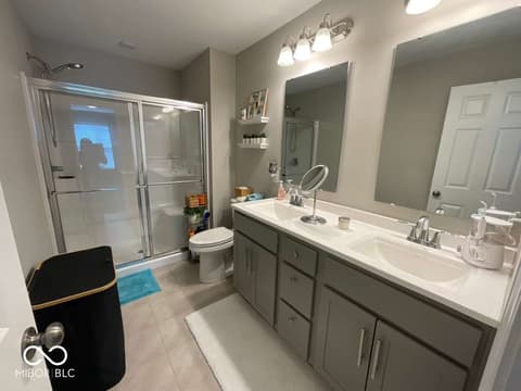 Primary bathroom at 19366 Goins Boulevard, Westfield, IN — Spacious primary bath with dual vanity and frameless shower.