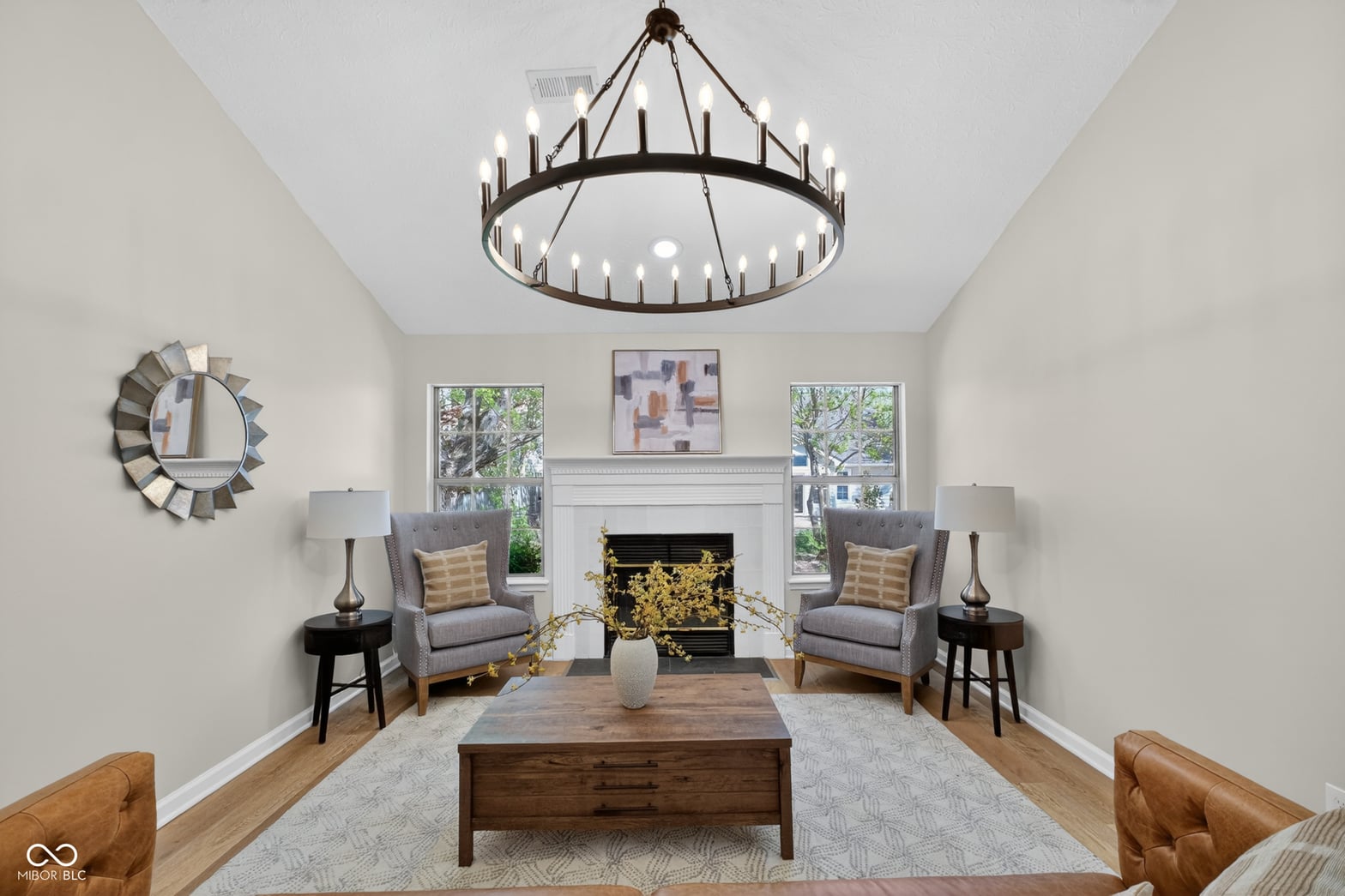 Bright, elegant living room with fireplace and soaring ceilings.
