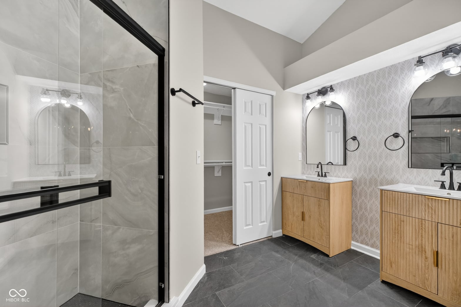 Luxurious primary bath with dual vanities and spacious walk-in shower.