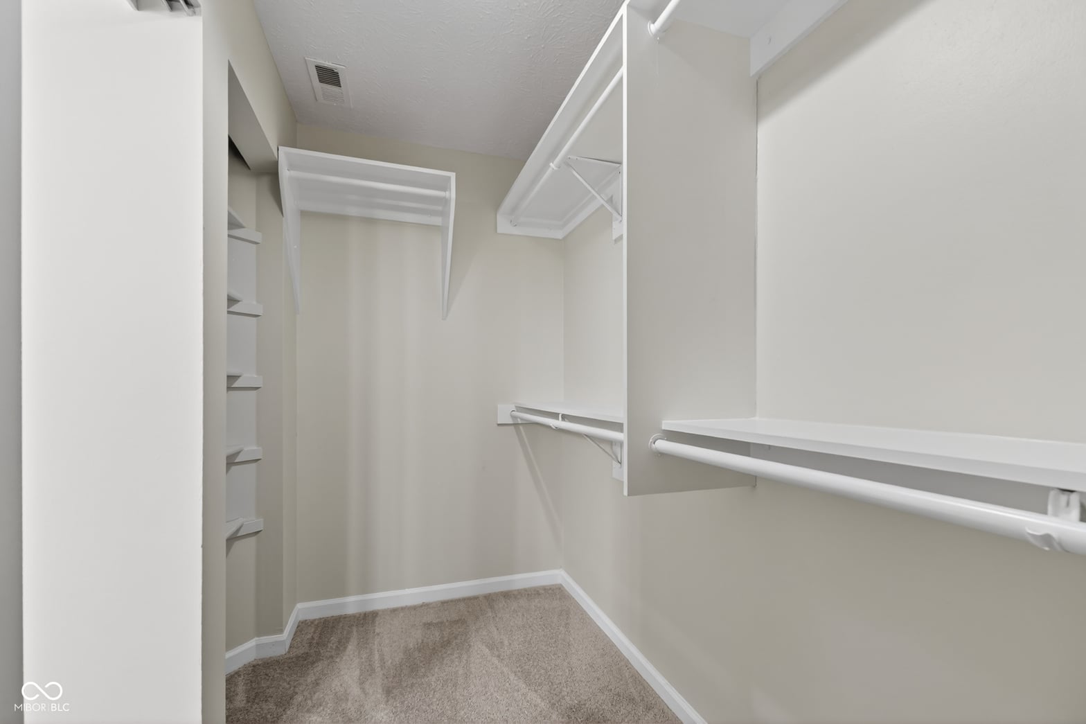 Spacious walk-in closet with organized built-in storage.