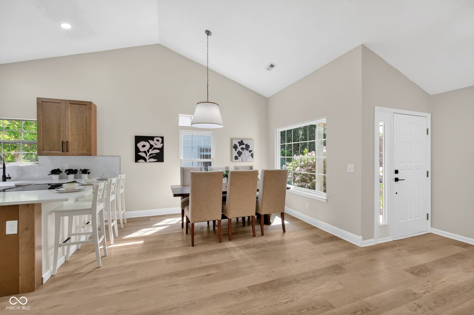 Bright open-concept kitchen with vaulted ceilings and abundant natural light.