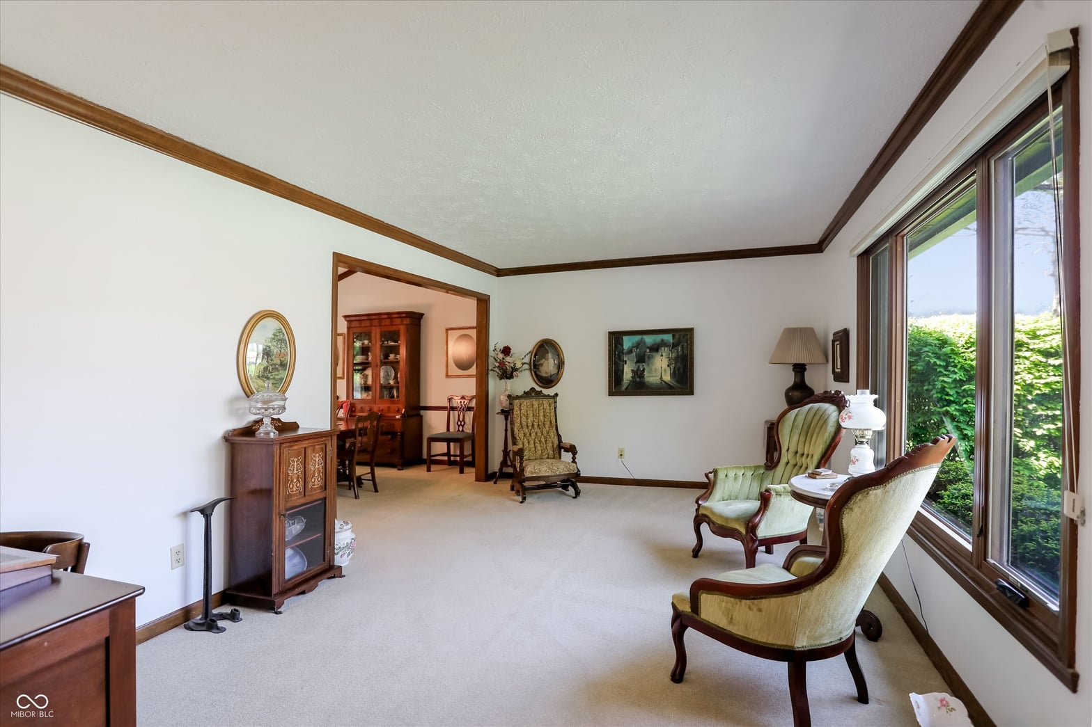 Elegant traditional living room with garden views and period furnishings.