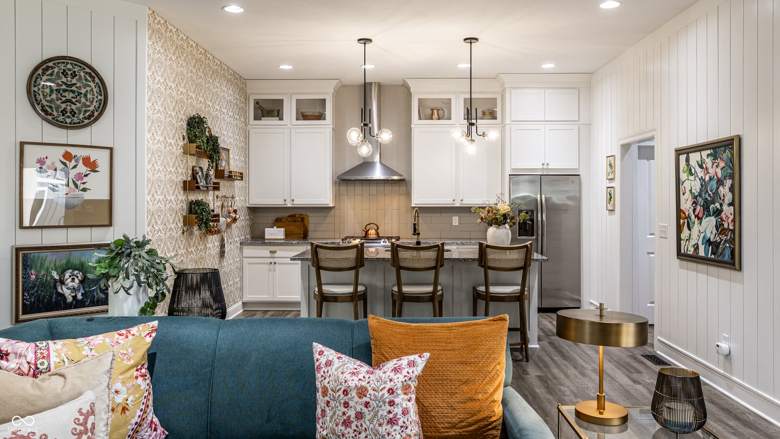 Bright, modern kitchen with island seating and pendant lights.