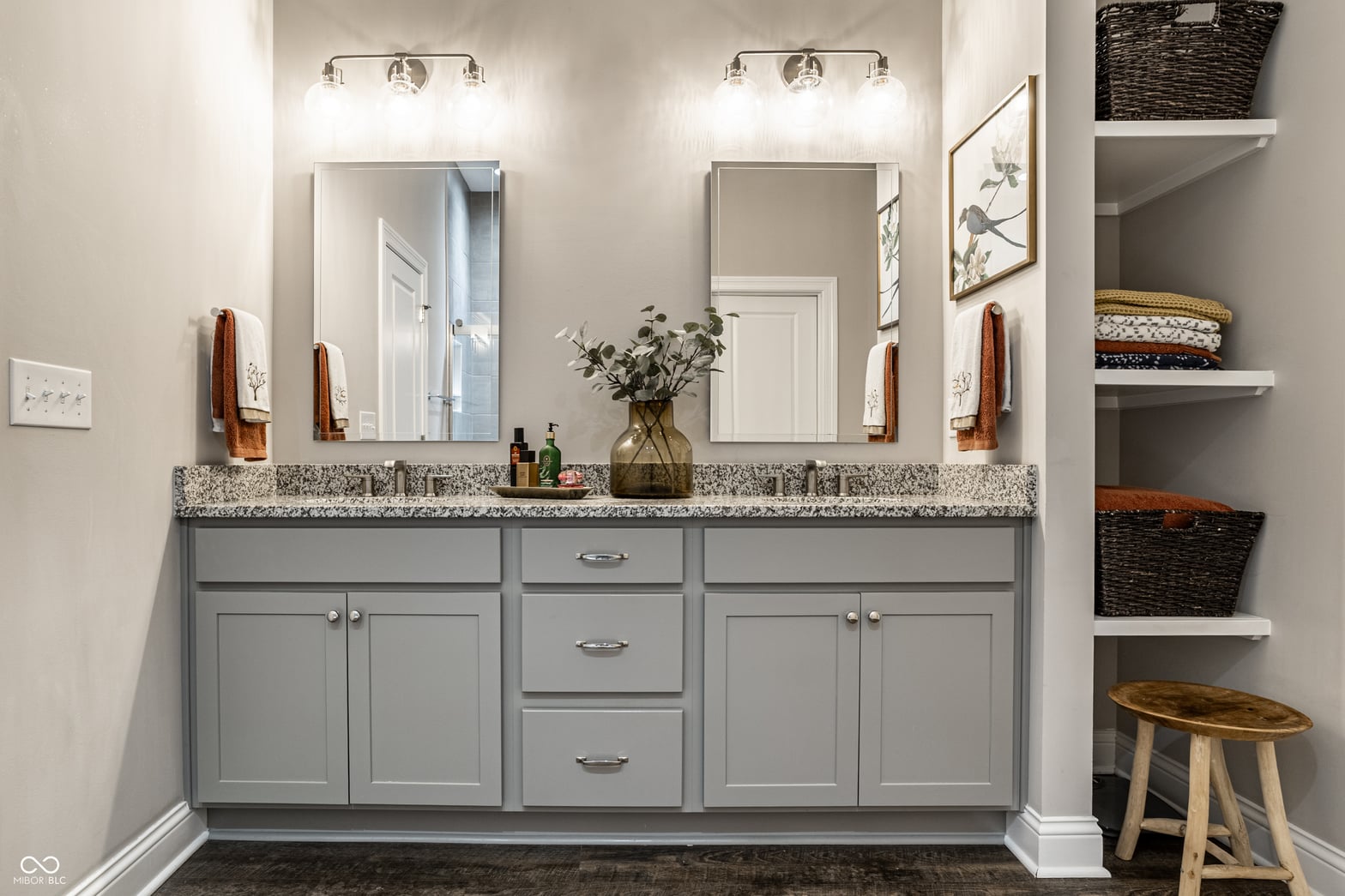 Spa-like primary bath with dual vanity and granite counters.