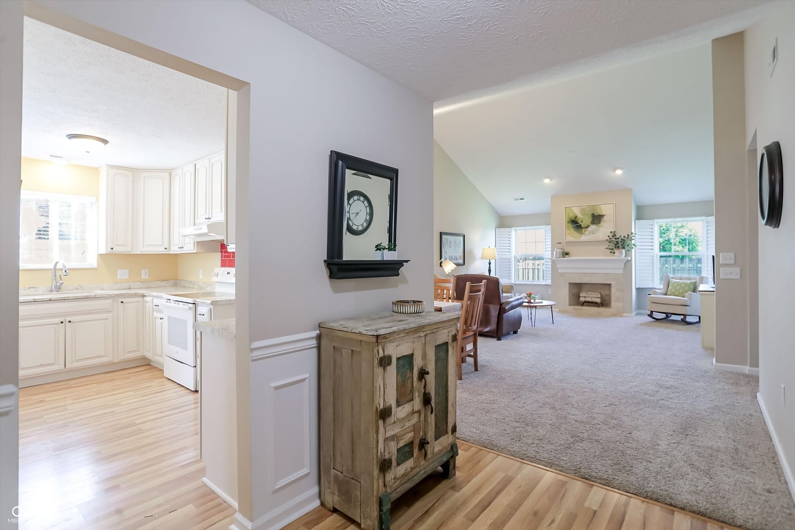 Bright, open living space with fireplace and natural light.