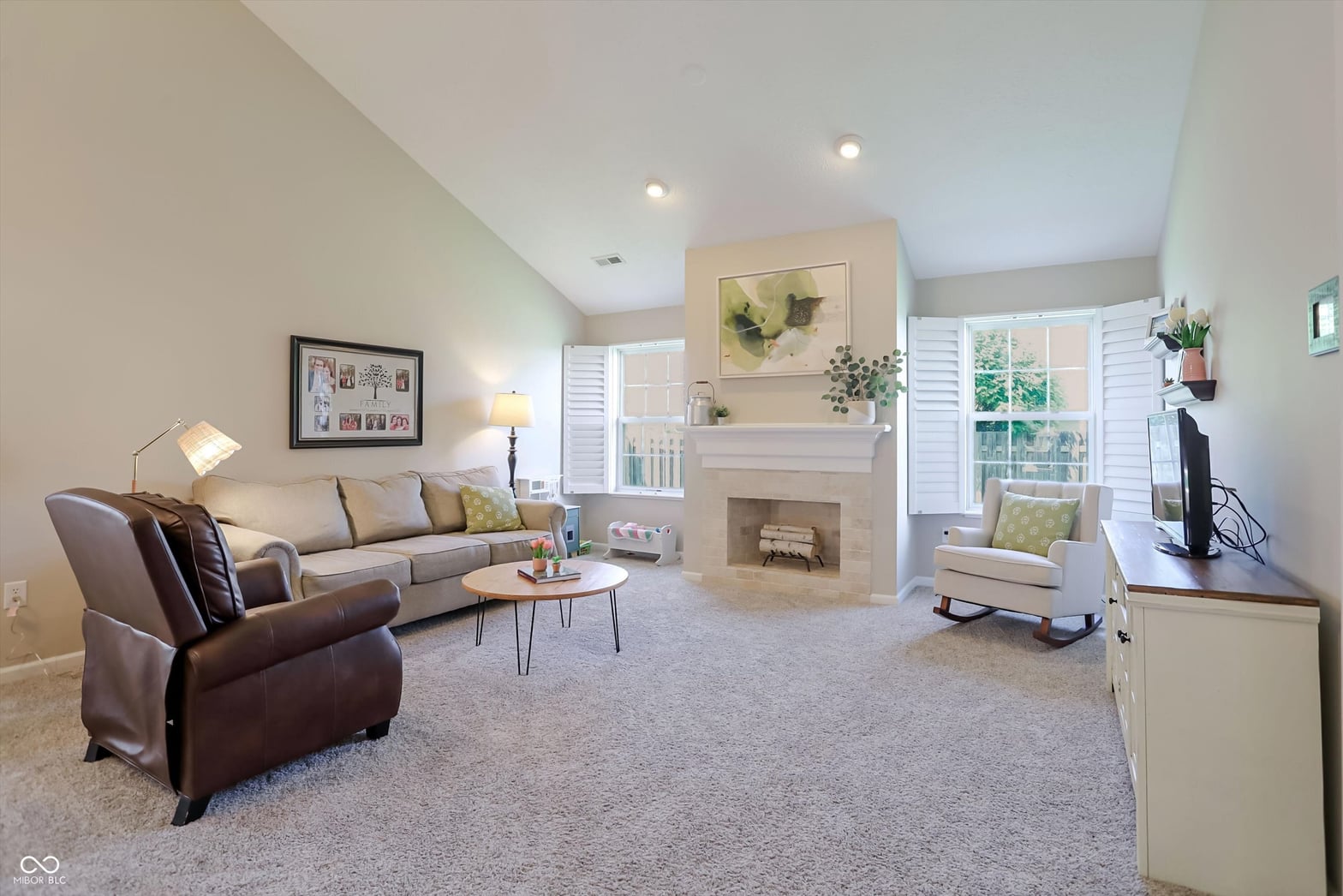 Bright family room with fireplace and abundant natural light.
