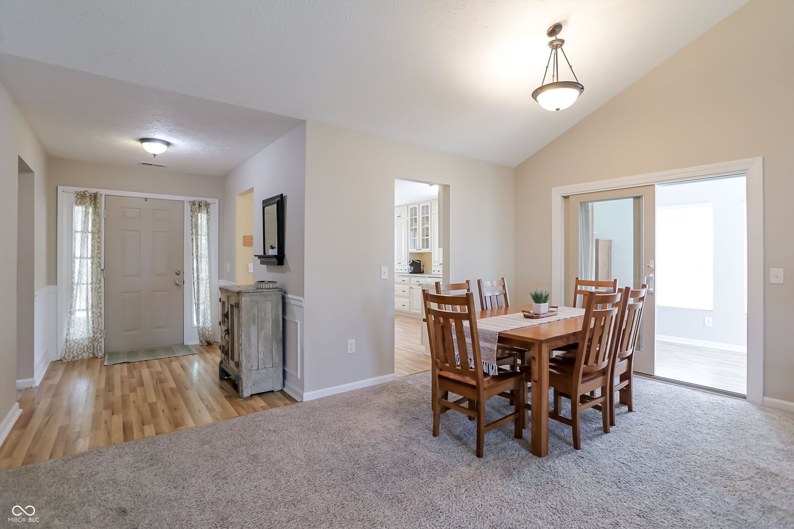 Bright open dining area with hardwood floors and patio access.