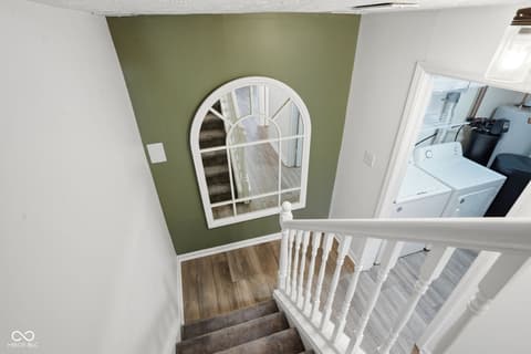 Hallway at 6048 S Bay Drive, Indianapolis, IN — Bright hallway with charming arched window and fresh paint.