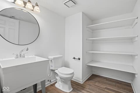 Primary bathroom at 6048 S Bay Drive, Indianapolis, IN — Modern primary bath with floating vanity and open shelving.