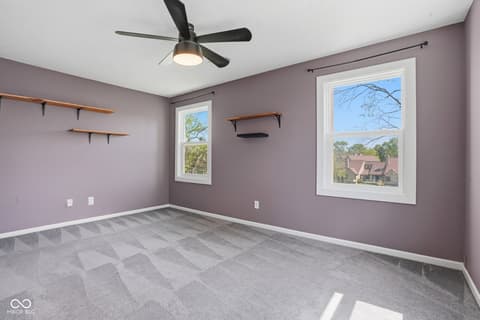 Bedroom at 6048 S Bay Drive, Indianapolis, IN — Bright bedroom with fresh purple walls and ample windows.