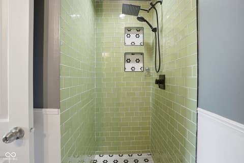 Primary bathroom at 6048 S Bay Drive, Indianapolis, IN — Modern spa shower with rainfall head and designer tilework.
