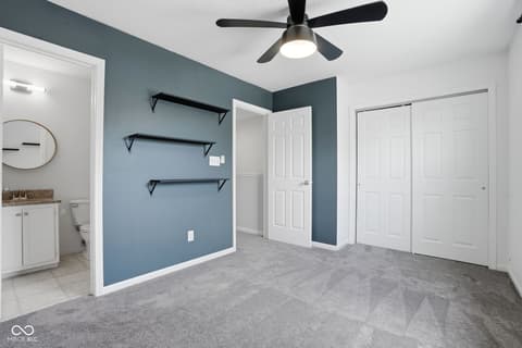 Primary bedroom at 6048 S Bay Drive, Indianapolis, IN — Spacious primary bedroom with ensuite and accent wall.