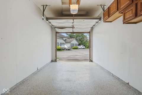 Garage at 6048 S Bay Drive, Indianapolis, IN — Spacious two-car garage with concrete floor and storage.