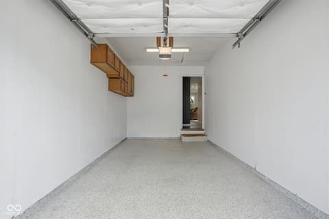 Garage at 6048 S Bay Drive, Indianapolis, IN — Single-car garage with storage cabinets and interior access.