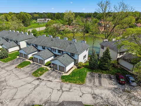 Aerial view at 6048 S Bay Drive, Indianapolis, IN — Waterfront townhomes with mature trees and pond views.