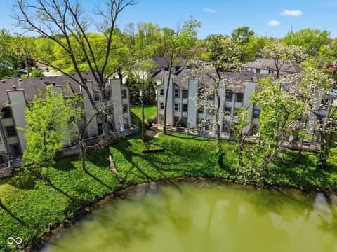 Aerial view at 6048 S Bay Drive, Indianapolis, IN — Waterfront complex with mature trees and green space.