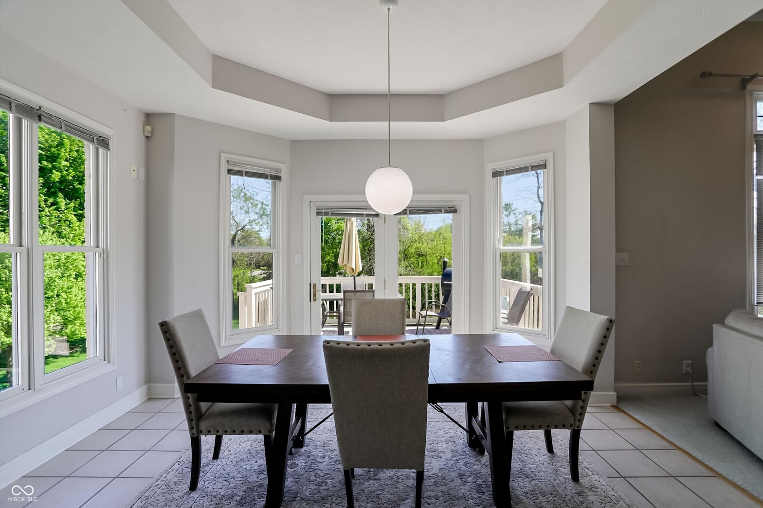 Bright dining room with coffered ceilings and French doors.
