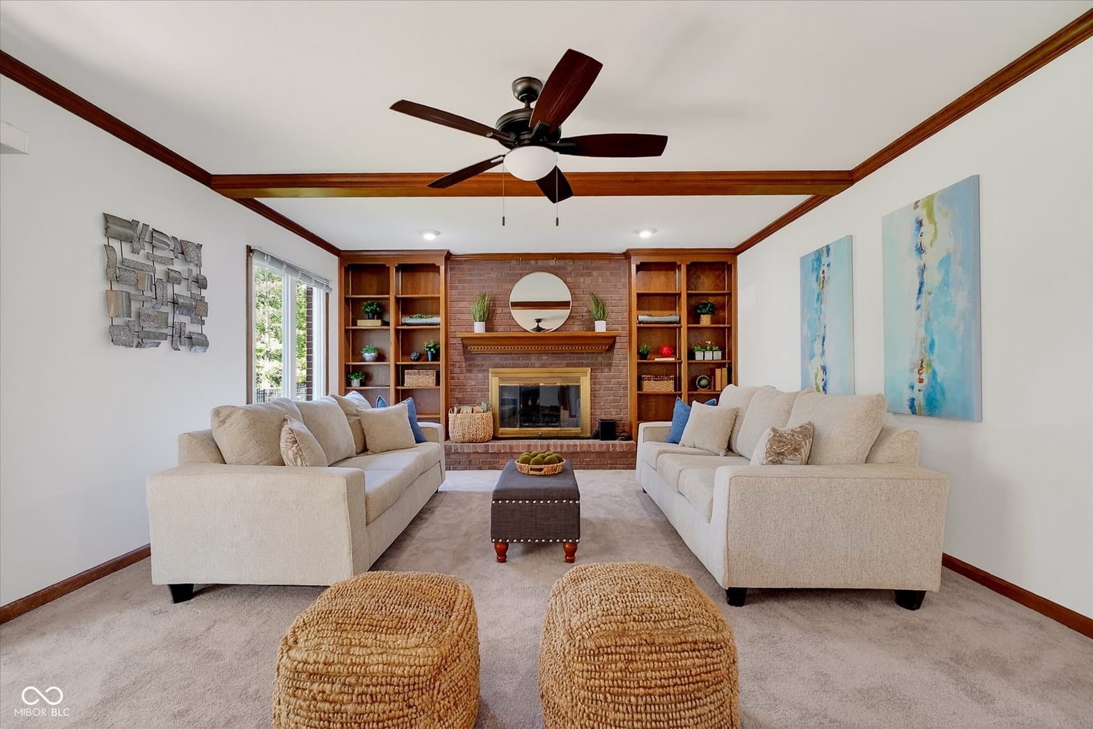 Spacious living room with fireplace and built-in shelving.
