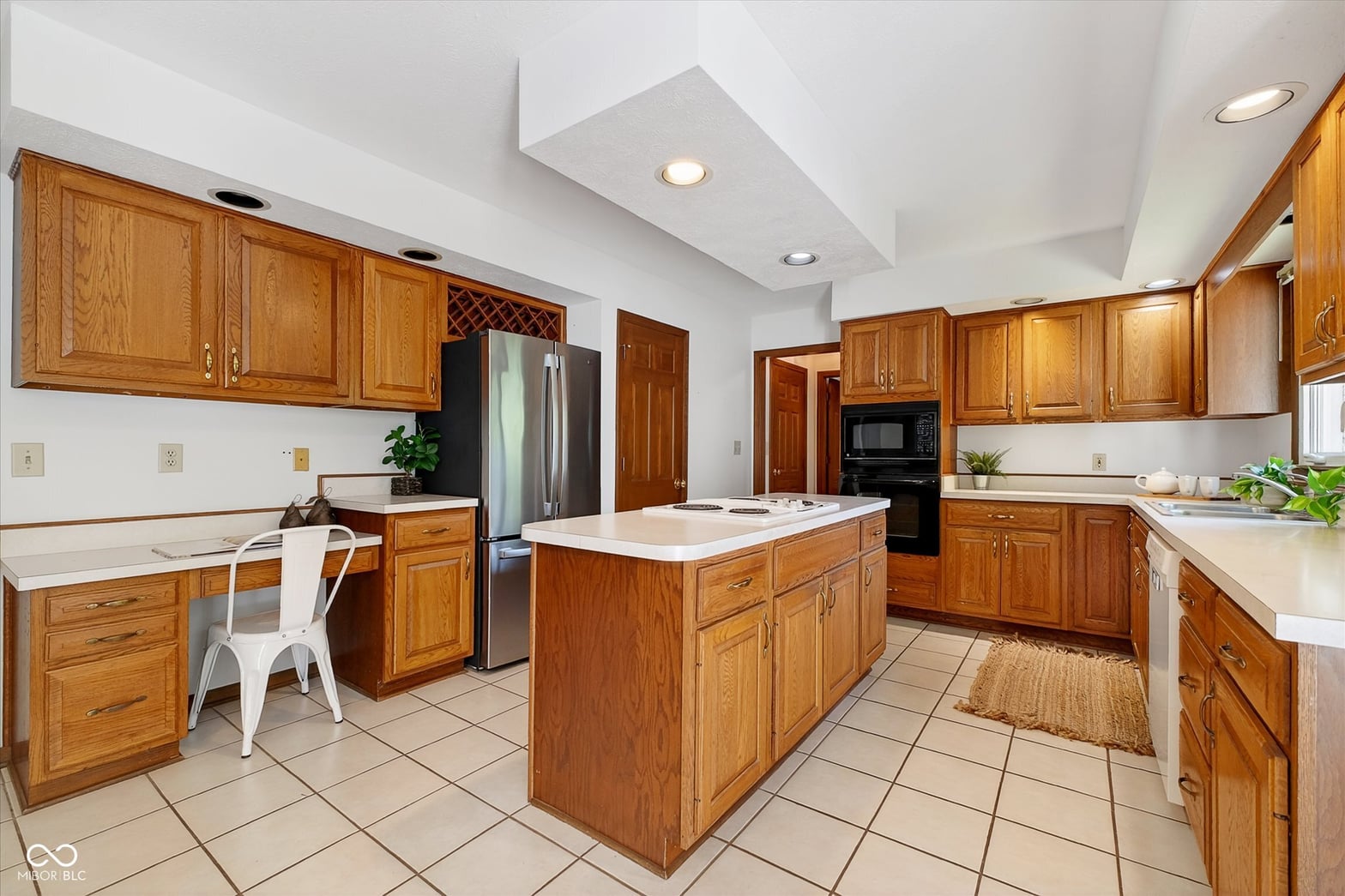 Spacious traditional kitchen with center island and stainless appliances.