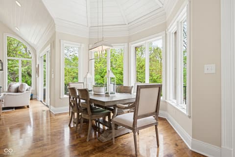 Dining room at 7436 Glenvista Place, Fishers, IN — Bright octagonal sunroom with skylights and garden views.