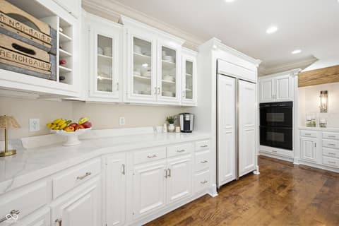 Kitchen at 7436 Glenvista Place, Fishers, IN — Bright white kitchen with marble counters and double ovens.