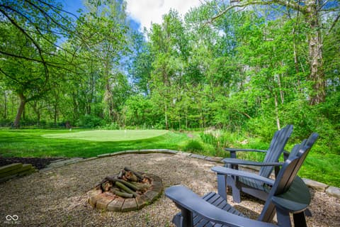 Yard at 7436 Glenvista Place, Fishers, IN — Serene wooded yard with fire pit and seating area.