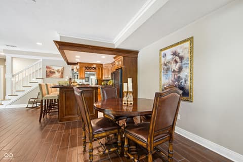 Dining room at 7436 Glenvista Place, Fishers, IN — Elegant dining area with rich wood tones and open layout.