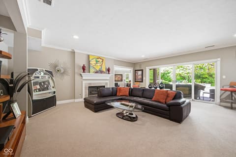 Family room at 7436 Glenvista Place, Fishers, IN — Spacious family room with fireplace and glass patio doors.