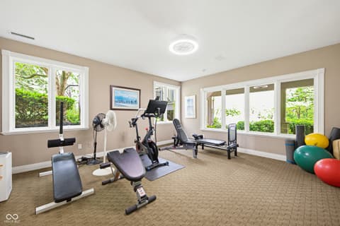 Bonus room at 7436 Glenvista Place, Fishers, IN — Bright home gym with abundant windows and modern equipment.