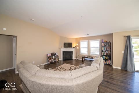 Family room at 14128 Stoney Shore Avenue, McCordsville, IN — Spacious family room with fireplace and hardwood floors.