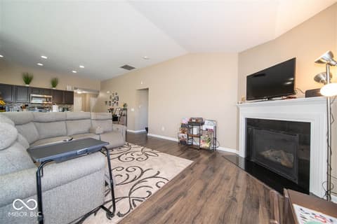 Family room at 14128 Stoney Shore Avenue, McCordsville, IN — Spacious open-concept family room with fireplace.
