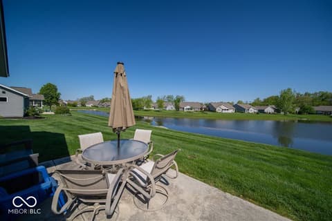 Outdoor living area at 14128 Stoney Shore Avenue, McCordsville, IN — Waterfront outdoor living space with lake views