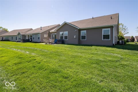 Backyard at 14128 Stoney Shore Avenue, McCordsville, IN — Large level backyard with mature landscaping and patios.
