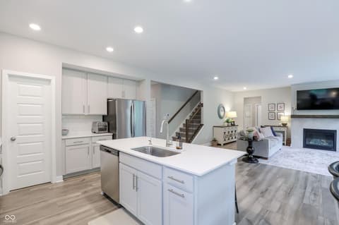 Kitchen at 17462 Cavalcade Circle, Noblesville, IN — Modern kitchen with island opens to living spaces.