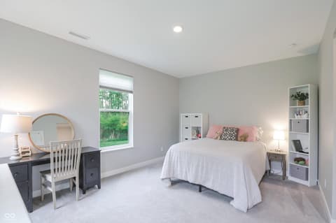 Primary bedroom at 17462 Cavalcade Circle, Noblesville, IN — Bright, spacious primary bedroom with vanity and built-ins.