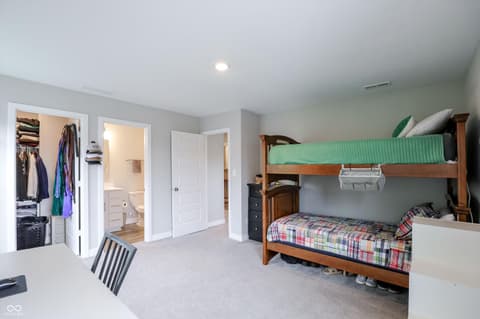 Bedroom at 17462 Cavalcade Circle, Noblesville, IN — Spacious bedroom with bunk beds and ensuite bathroom.