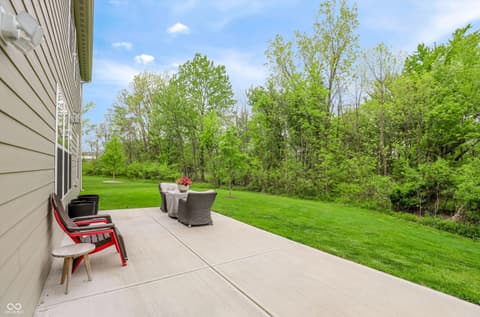 Backyard at 17462 Cavalcade Circle, Noblesville, IN — Spacious backyard patio with mature trees and privacy.