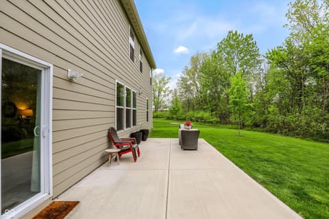 Backyard at 17462 Cavalcade Circle, Noblesville, IN — Spacious back patio with pristine lawn and mature trees.