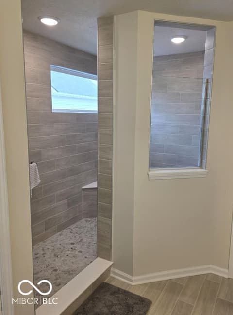 Primary bathroom at 852 Cowley Drive, Westfield, IN — Luxurious walk-in shower with modern gray tile design.