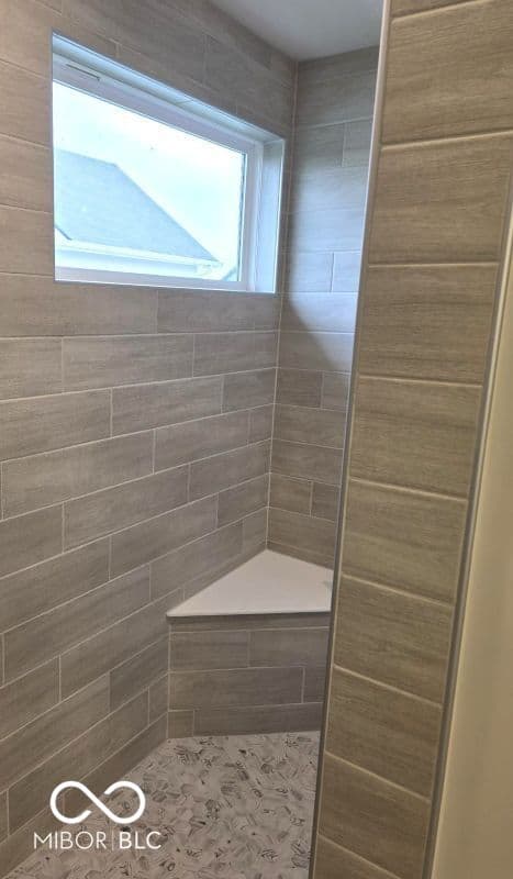 Primary bathroom at 852 Cowley Drive, Westfield, IN — Spacious modern shower with bench and natural light.