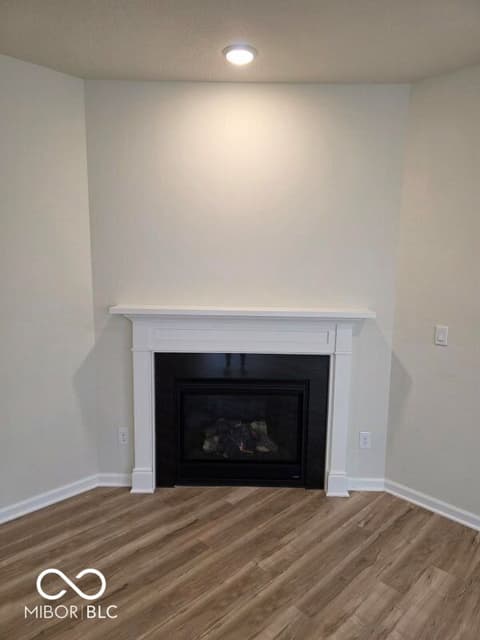 Living room at 852 Cowley Drive, Westfield, IN — Modern gas fireplace with elegant white surround.