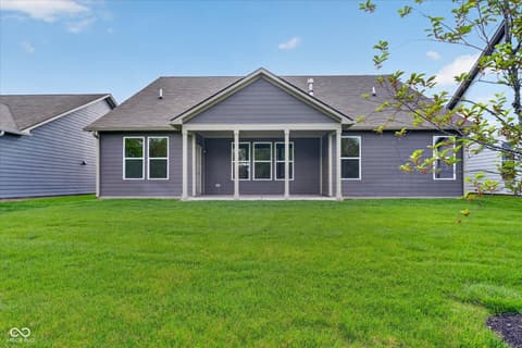 Yard at 20237 Willenhall Court, Westfield, IN — Expansive manicured lawn with mature tree line.