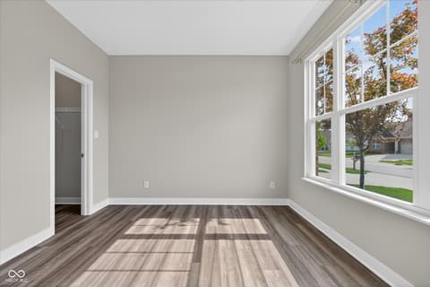 Bedroom at 20237 Willenhall Court, Westfield, IN — Bright bedroom with expansive windows and fresh finishes.