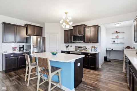 Kitchen at 14680 Hinton Drive, Fishers, IN — Modern kitchen with bright blue island and premium finishes.