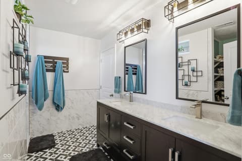 Primary bathroom at 14680 Hinton Drive, Fishers, IN — Luxurious primary bath with marble finishes and dual vanity.