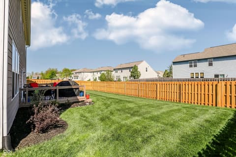 Backyard at 14680 Hinton Drive, Fishers, IN — Spacious fenced backyard with new wooden privacy fence.